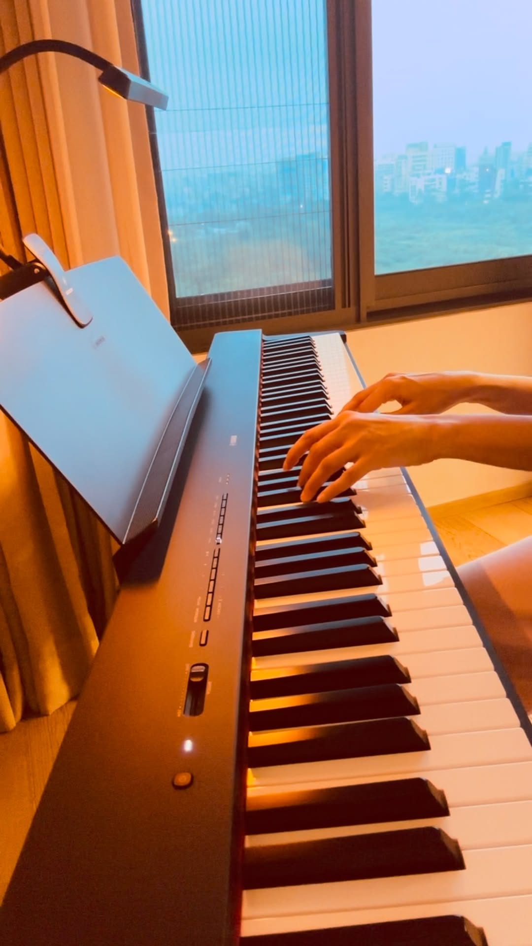 Naina at the piano, working a tune out by ear